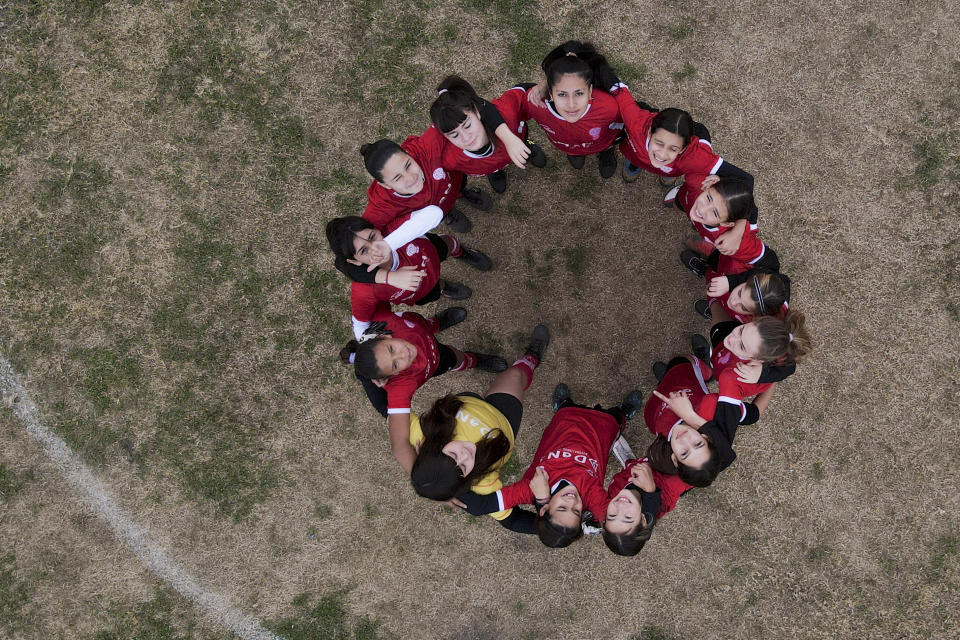 Players from the Huracan female soccer team poses for a photo prior to a match against Alumni in Arequito, Santa Fe province, Argentina, Monday, June 19, 2023. The encounter is part of a regional women's soccer league in the south of the Argentine province of Santa Fé, where until recently, there were no female teams or tournaments. (AP Photo/Natacha Pisarenko)