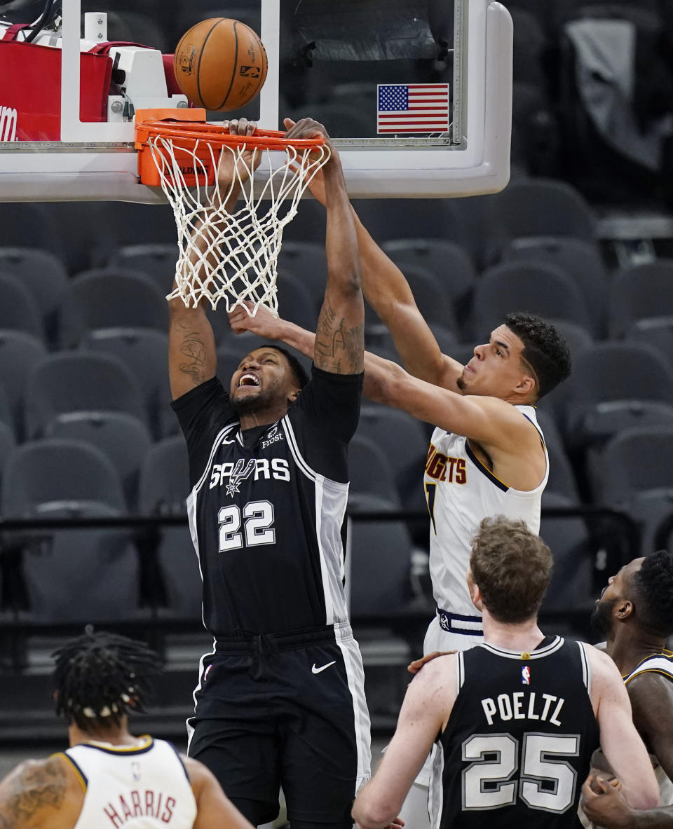 San Antonio Spurs forward Rudy Gay (22) is blocked by Denver Nuggets forward Michael Porter Jr. (1) as he tries to score during the second half of an NBA basketball game in San Antonio, Friday, Jan. 29, 2021. (AP Photo/Eric Gay)