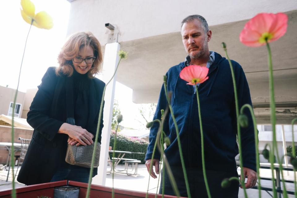 Sarah Dusseault, left, spends time with her brother, John Maurer in the garden at the board and care home in Hollywood.