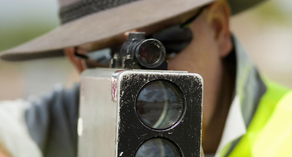 A man holds a speed camera.