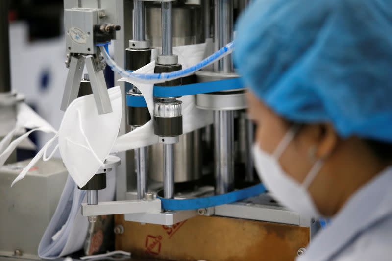 An employee works in an assembly line at a mask factory in Icheon