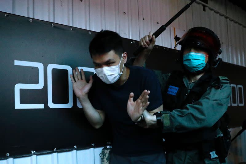 Anti-government protester detained by riot police in Hong Kong