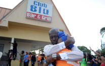 <p>David Fairman Jackson and Nikki Lynch Escobar hold one another during a prayer vigil outside of the Club Blu after a shooting attack at a nightclub in Fort Myers, Fla., on July 25, 2016. (REUTERS/Chris Tilley)</p>