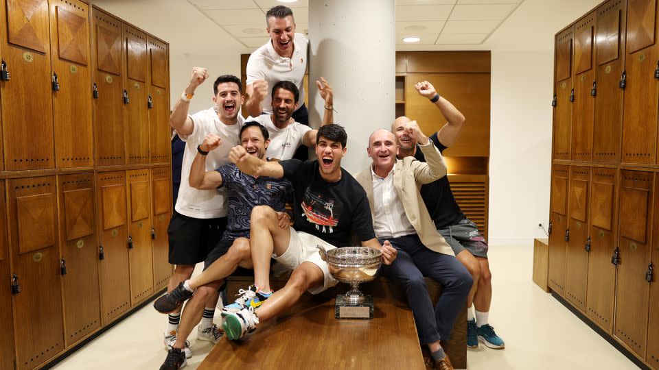 Alcaraz and his team pose for a photo in the locker room after winning the French Open. - Clive Brunskill/Getty Images