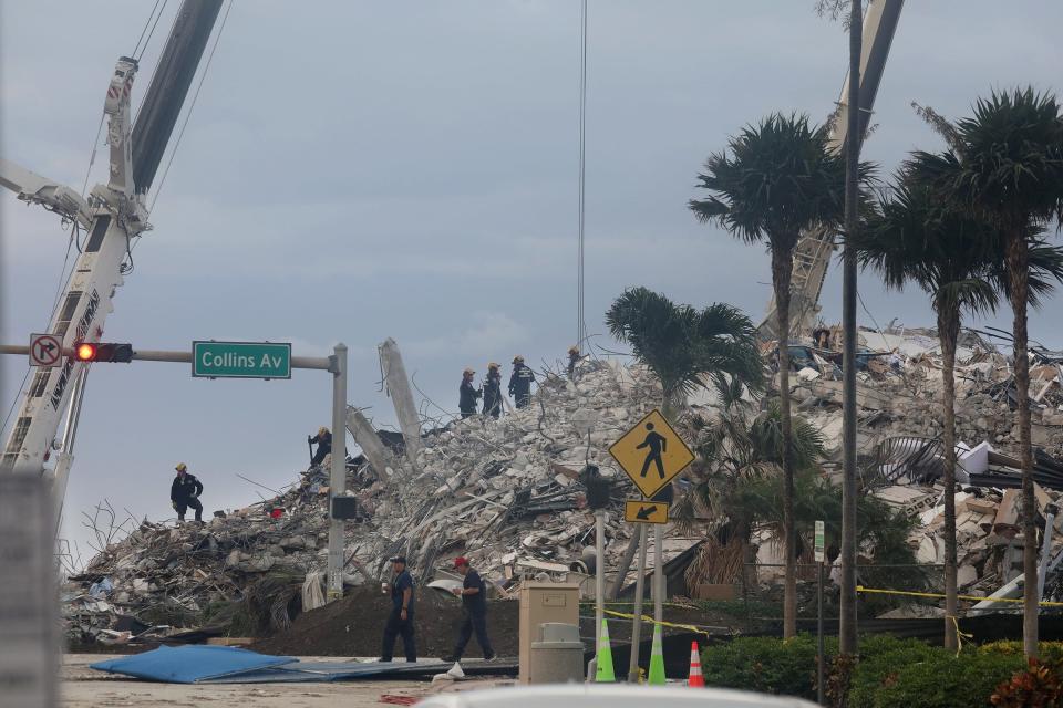 Search and rescue crews work on top of the rubble of the Champlain Towers South condo in Surfside, Florida July 5, 2021 after the remaining portions of the collapsed condo was leveled by controlled implosion Sunday night.