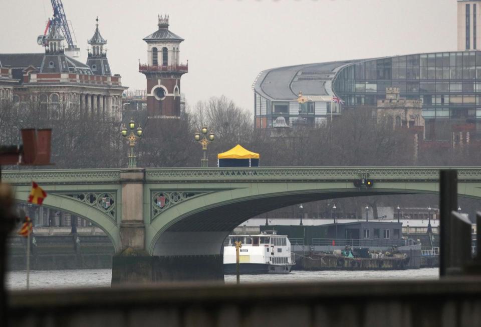 Sombre image: A forensic tent was erected on the landmark (Jonathan Brady/PA)