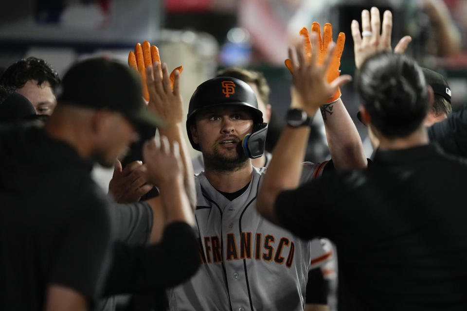 San Francisco Giants' J.D. Davis celebrates in the dugout after hitting a home run during the seventh inning of a baseball game against the Los Angeles Angels in Anaheim, Calif., Monday, Aug. 7, 2023. (AP Photo/Ashley Landis)