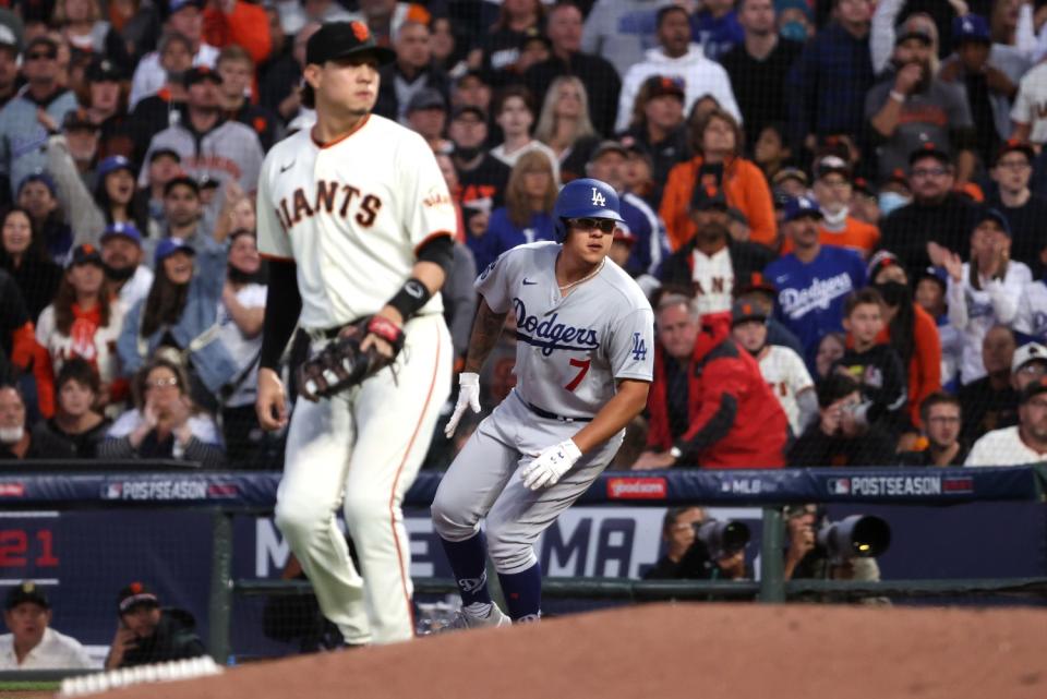 Dodgers pitcher Julio Urias reaches first base on an RBI single.