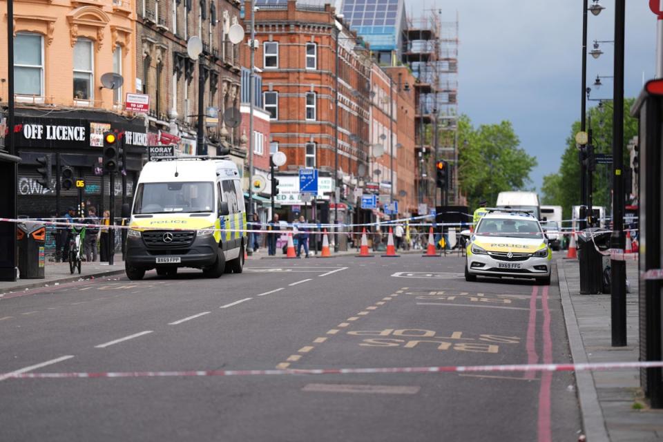 Police at the scene of the shooting in Kingsland High Street, Hackney, east London (PA Wire)