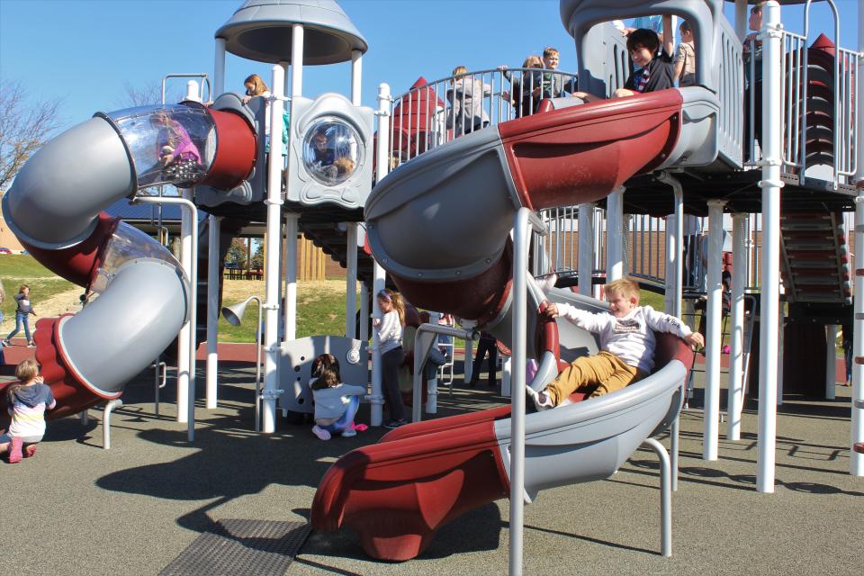 As recess progresses more children test out different areas of the playset with friends