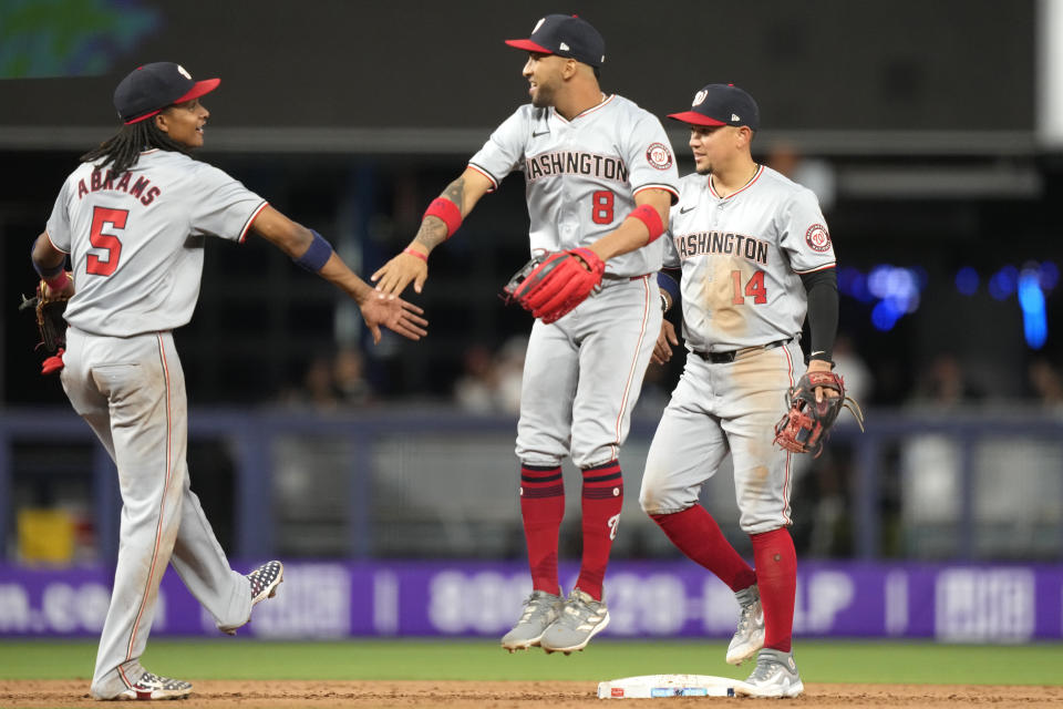 Washington Nationals shortstop CJ Abrams (5), center fielder Eddie Rosario (8) and second baseman Ildemaro Vargas (14) celebrate after their victory over the Miami Marlins in a baseball game, Monday, April 29, 2024, in Miami. (AP Photo/Lynne Sladky)