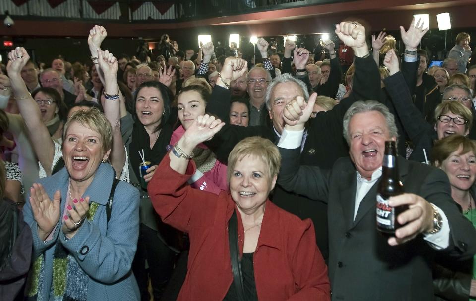 Quebec Liberal party supporters react as they watch the results on election night, Monday, April 7, 2014, in Saint-Felicien, Quebec. The Liberal Party won Quebec's legislative elections Monday, in a crushing defeat for the main separatist party and major setback for the cause of independence in the French-speaking province. (AP Photo/The Canadian Press, Clement Allard)