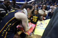 CORRECTS FROM CAITLYN TO CAITLIN - Indiana Fever guard Caitlin Clark, left, signs autographs for Iowa fans after Indiana lost to the Dallas Wings during an WNBA basketball game in Arlington, Texas, Friday, May 3, 2024. (AP Photo/Michael Ainsworth)