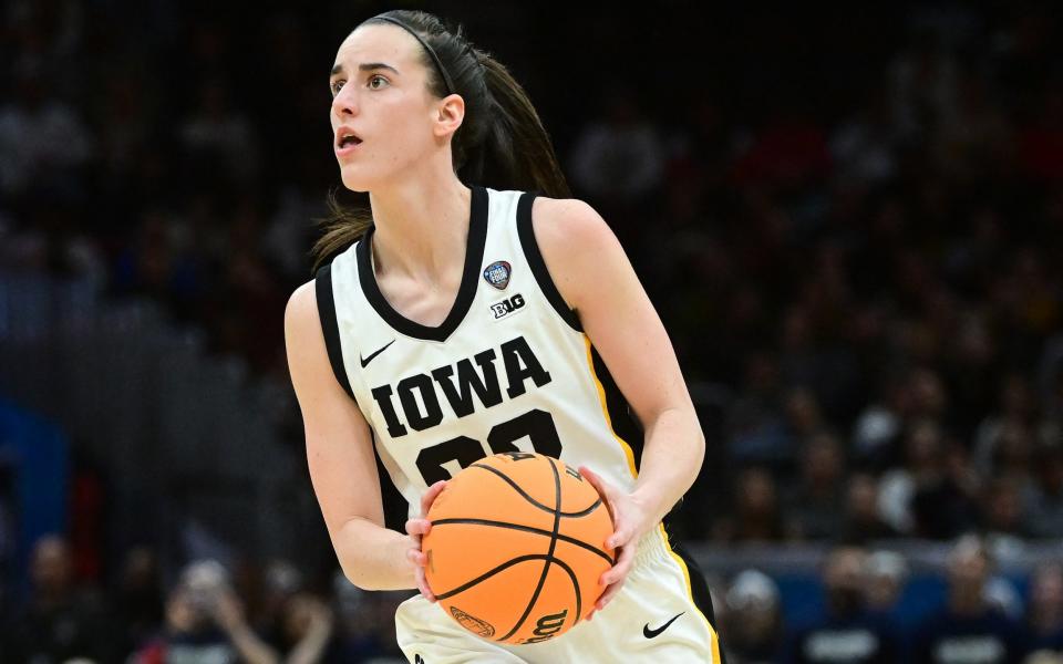 Iowa Hawkeyes guard Caitlin Clark (22) dribbles the ball against the Connecticut Huskies during the semifinals of the 2024 Women's NCAA Tournament Final Four at Rocket Mortgage Fieldhouse.