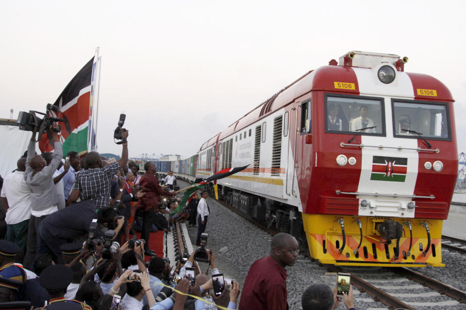 FILE - In this May 30, 2017, file photo, a Standard Gauge Railway cargo train rides from the port container depot on a Chinese-backed railway costing nearly $3.3 billion, opened by Kenya's president as one of the country's largest infrastructure projects since independence, in Mombasa, Kenya. African leaders in 2020 are asking what China can do for them as the coronavirus pandemic threatens to destroy economies across a continent where Beijing is both the top trading partner and top lender. (AP Photo/Khalil Senosi, File)