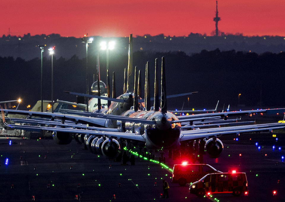 Aircrafts are parked on a runway at the airport in Frankfurt, Germany, Sunday, March 15, 2020. Due to the Coronavirus, Lufthansa had to cancel half of its flights. For most people, the new coronavirus causes only mild or moderate symptoms. For some, it can cause more severe illness, especially in older adults and people with existing health problems. (AP Photo/Michael Probst)