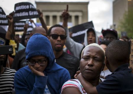 Residents who marched from west Baltimore to City Hall, react to the protest leaders who were chronicling the arrest and death of Freddie Gray, in Baltimore, Maryland April 30, 2015. REUTERS/Adrees Latif