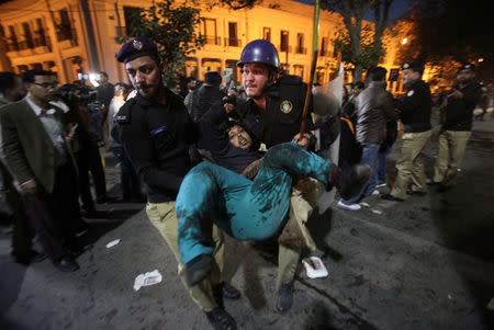 A policeman carries one of the injured after a blast in Lahore, Pakistan February 13, 2017. REUTERS/Mohsin Raza