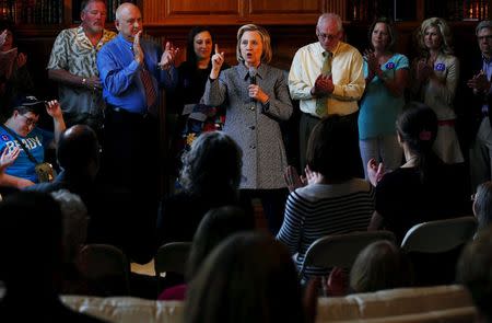 U.S. presidential candidate Hillary Clinton (C) is applauded as she speaks to supporters at a campaign event in Mason City, Iowa, United States, May 18, 2015. REUTERS/Jim Young