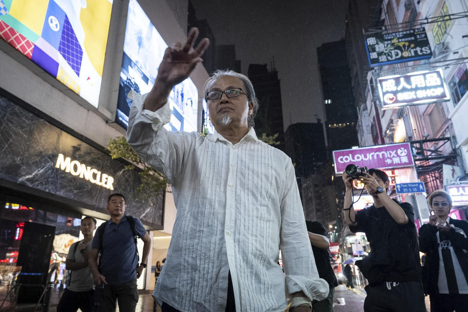 Artist Sanmu Chen performs on the street in the Causeway Bay area on the eve of the 35th anniversary of China's Tiananmen Square crackdown in Hong Kong, Monday, June 3, 2024. (AP Photo/Chan Long Hei)