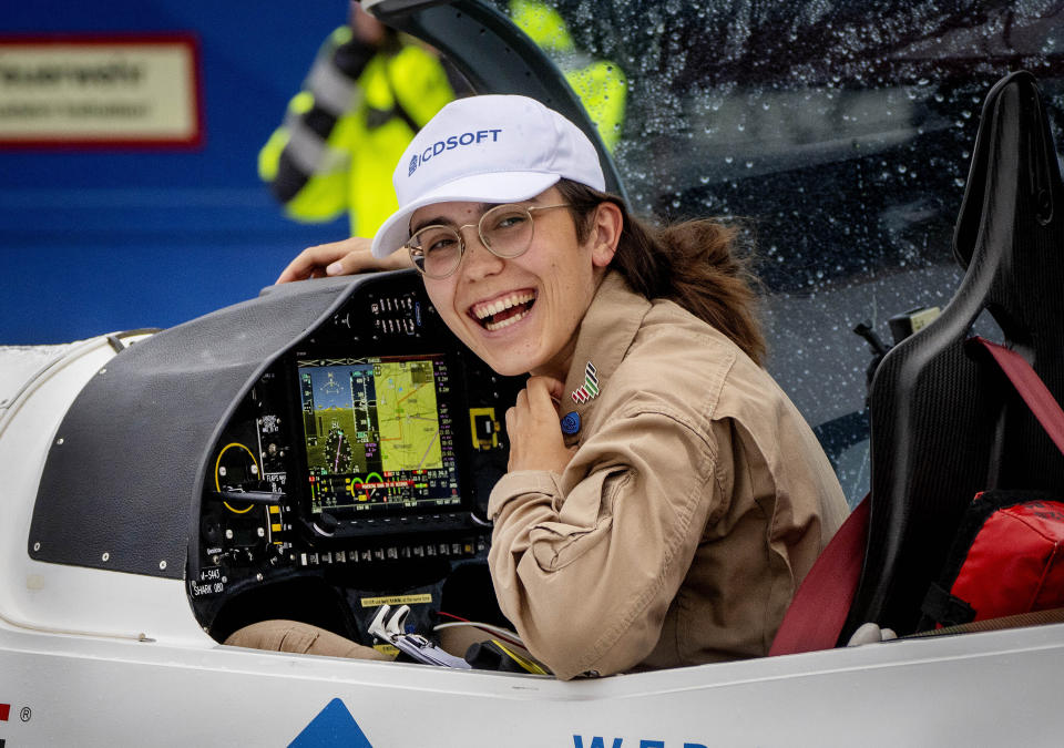 Belgium-British teenage pilot Zara Rutherford smiles after she landed with her Shark ultralight plane at the Egelsbach airport in Frankfurt, Germany, Wednesday, Jan.19, 2022. At the age of 19, she is set to land her single-seater Shark sport aircraft in Kortrijk, Belgium, on Monday, more than 150 days after setting out to become the youngest woman to circumnavigate the world solo. American aviator Shaesta Waiz was 30 when she set the previous benchmark.(AP Photo/Michael Probst)