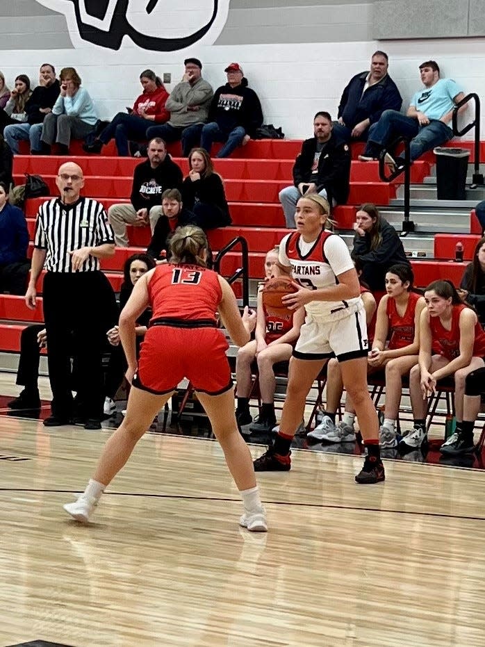 Pleasant's Lexi Olt looks for a teammate while being guarded by Cardington's Genevieve Longsdorf during a girls basketball game last week at home.