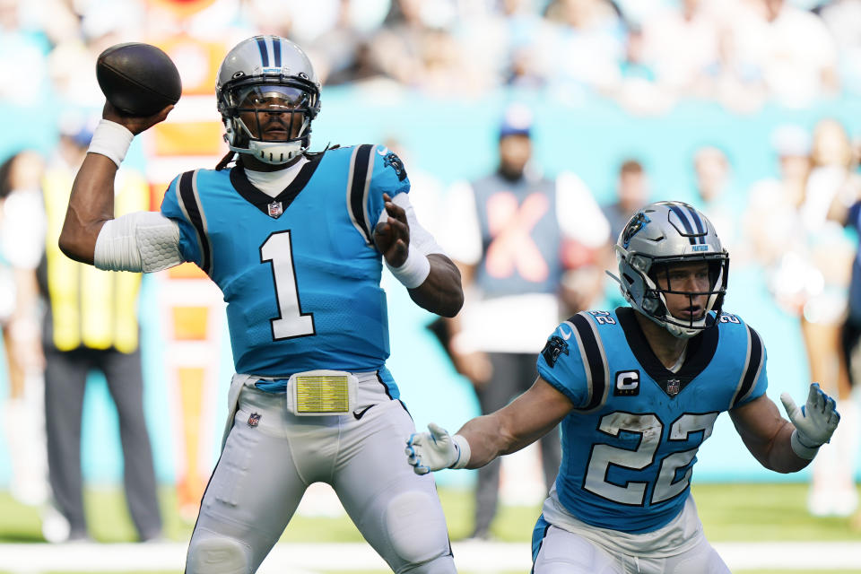 Carolina Panthers quarterback Cam Newton (1) aims a pass as running back Christian McCaffrey (22) defends, during the first half of an NFL football game against the Miami Dolphins, Sunday, Nov. 28, 2021, in Miami Gardens, Fla. (AP Photo/Wilfredo Lee)