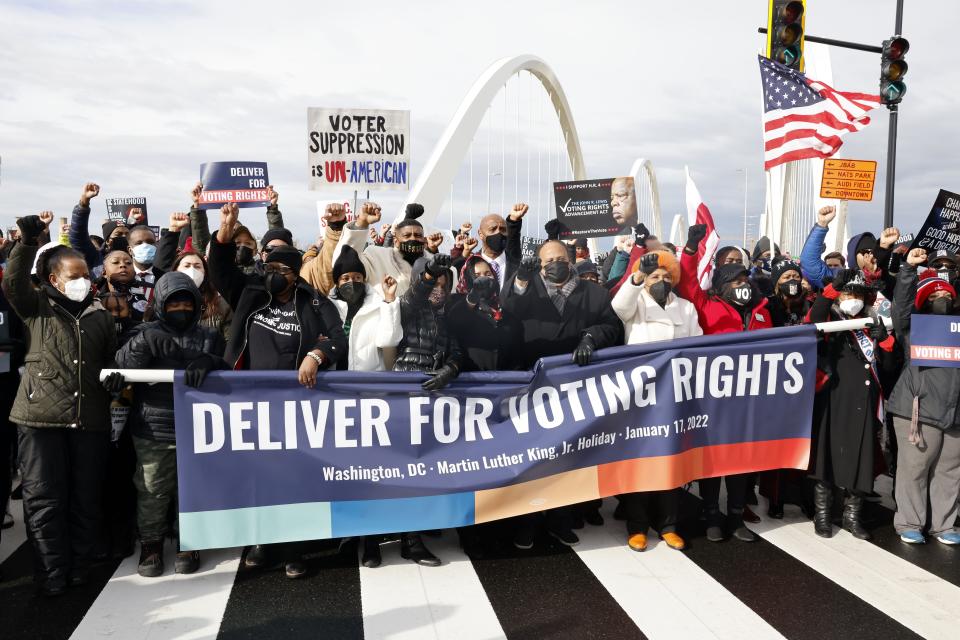 Martin Luther King III, center, and his family are joined by members of Congress Rep. Joyce Beatty (D-OH), center 2nd right, and Rep. Terri Sewell (D-AL), center right, and others to cross the Frederick Douglas Memorial Bridge to call on the Senate to pass voting rights legislation, Monday in Washington, D.C. [PAUL MORIGI/AP IMAGES FOR DELIVER FOR VOTING RIGHTS]