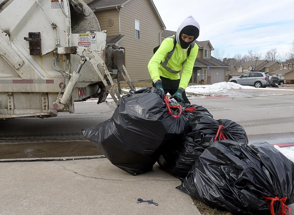 City of Columbia refuse collector Omar Wright gathers trash on Feb. 9, 2022 in south Columbia.