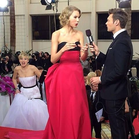 Jennifer Lawrence photobombs Taylor Swift on the Golden Globes red carpet.