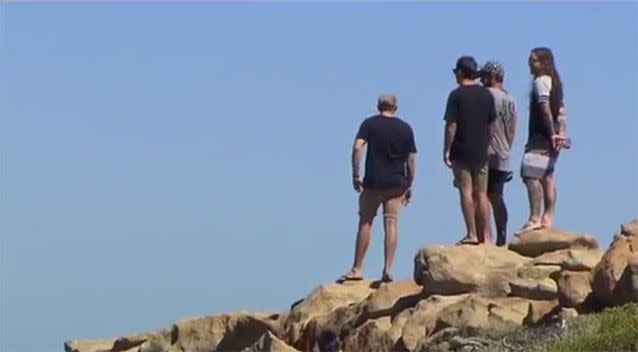 Friends of Mr Bache look on as the search for the young man continued on Wednesday. Photo: 7 News