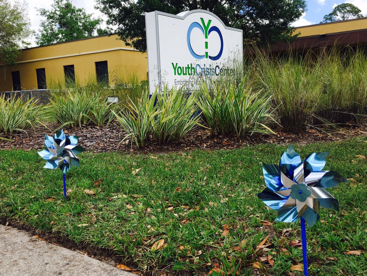 The Youth Crisis Center on Parental Home Road is shown adorned with blue pinwheels in April to mark Child Abuse Awareness Month.