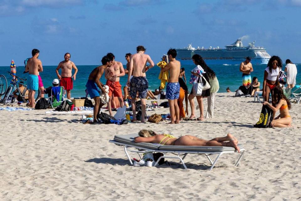 People hang out on the beach during spring break in Miami Beach on Friday, March 15, 2024.