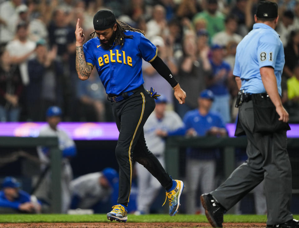 Seattle Mariners' J.P. Crawford gestures as he scores against the Kansas City Royals during the eighth inning of a baseball game Friday, Aug. 25, 2023, in Seattle. (AP Photo/Lindsey Wasson)