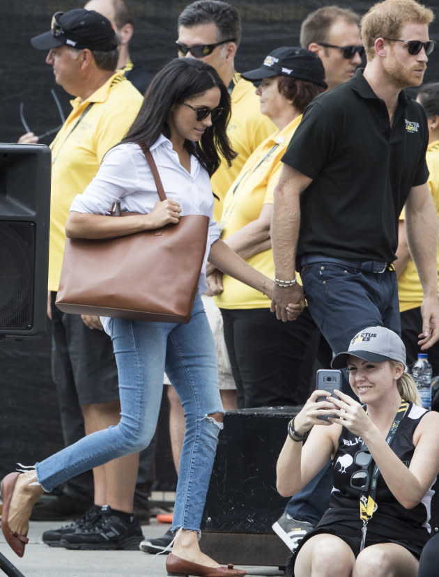 The royal couple were spotted holding hands at the Invictus Games tennis match [Photo: Getty]