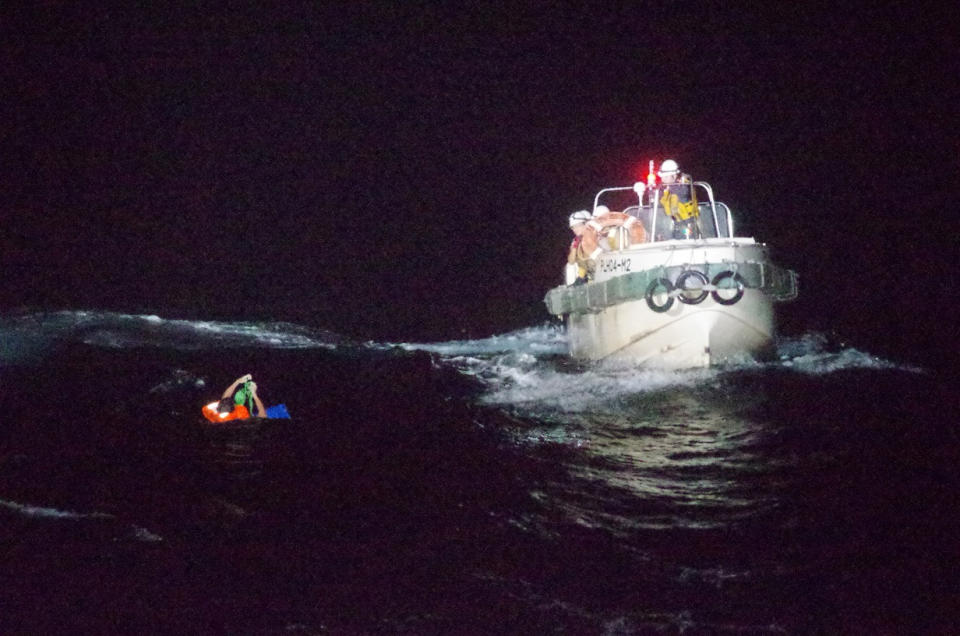 A Filipino crew member believed to be onboard Gulf Livestock 1, a cargo ship carrying livestock and dozens of crew members that went missing after issuing a distress signal due to Typhoon Maysak, is rescued by a Japan Coast Guard boat during their search and rescue operation at the East China Sea, to the west of Amami Oshima island in southwestern Japan.