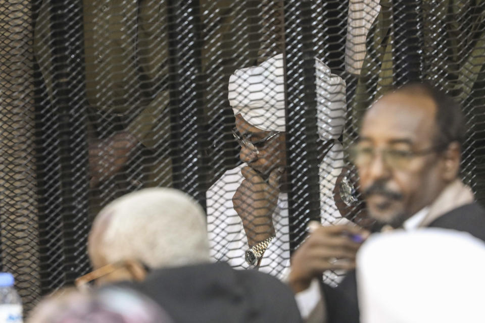 Sudan's autocratic former President Omar al-Bashir sits in a cage during his trial on corruption and money laundering charges in Khartoum, Sudan, Saturday, Aug. 24, 2019. (AP Photo)