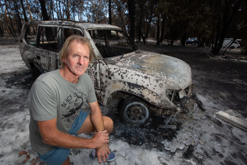 Resident Brian Williams returns to survey the damage to his resort accommodation and equipment at Lake Cooroibah Road in Noosa Shire.