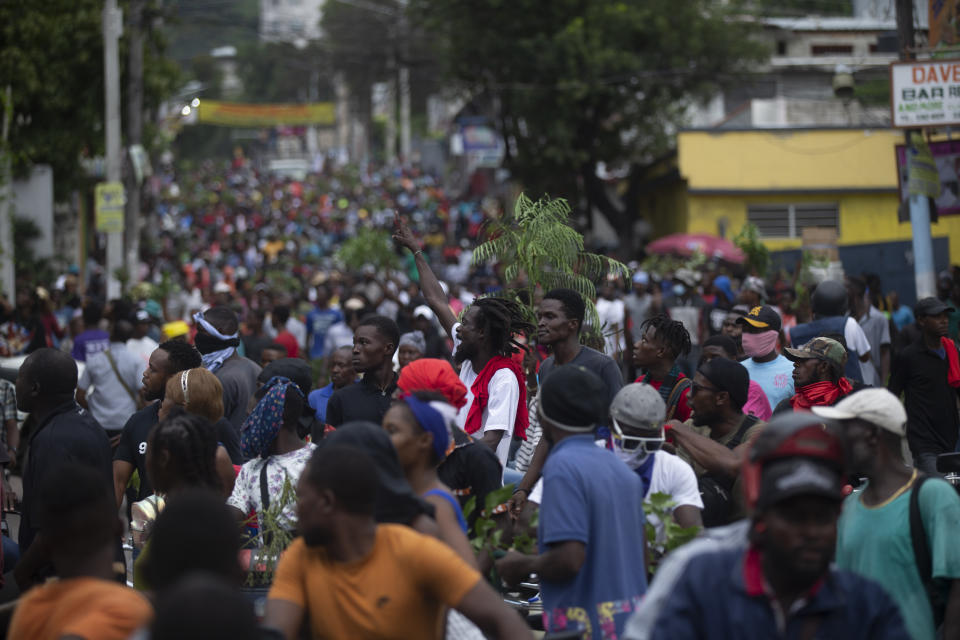 Demonstrators fill the streets during a protest in Port-au-Prince, Haiti, Monday, Aug. 22, 2022. Protesters marched through Haiti's capital and other major cities, blocking roads and shutting down businesses to demand that Prime Minister Ariel Henry step down and call for a better quality of life. (AP Photo/Odelyn Joseph)