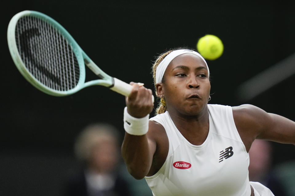 Coco Gauff of the United States plays a forehand return to compatriot Emma Navarro during their fourth round match at the Wimbledon tennis championships in London, Sunday, July 7, 2024. (AP Photo/Alberto Pezzali)