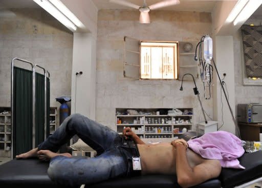 A Syrian civilian who was wounded during clashes between Syrian troops and rebels rests at a makeshift clinic in the northern city of Aleppo. A commercial hub and home to 2.5 million people, Syria's second city Aleppo has become a new front in the country's 16-month uprising, after being largely excluded from the violence