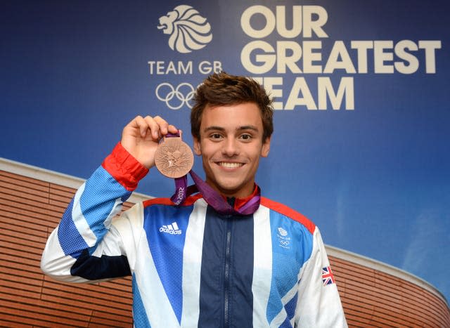 Tom Daley poses with his bronze medal