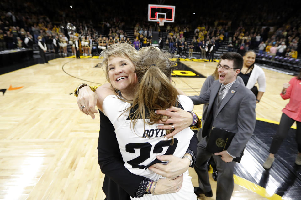 FILE - In this March 24, 2019, file photo, Iowa coach Lisa Bluder gets a hug from guard Kathleen Doyle (22) after the team's second-round game against Missouri in the NCAA women's college basketball tournament in Iowa City, Iowa. Iowa has won six straight games and is on a 30-game home win streak, second-longest in the nation behind Baylor's 49-game streak. (AP Photo/Charlie Neibergall, File)