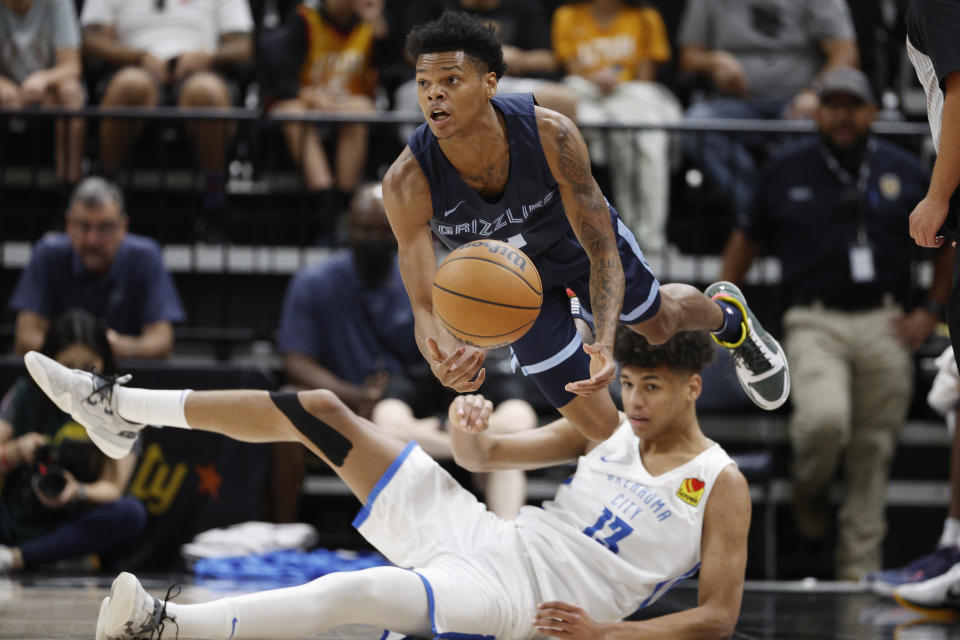 Memphis Grizzlies guard Ronaldo Segu, top, gets off a pass against Oklahoma City Thunder forward Ousmane Dieng (13) during the first half an NBA summer league basketball game Wednesday, July 6, 2022, in Salt Lake City. (AP Photo/Jeff Swinger)