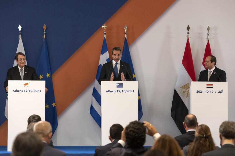 Greece's Prime Minister Kyriakos MItsotakis, center, Cyprus' President Nicos Anastasiades, left, and Egypt's President Abdel Fattah al-Sisi make statements following a meeting in Athens, Greece, Tuesday, Oct. 19, 2021. Athens hosts the 9th trilateral meeting between the three countries. (AP Photo/Yorgos Karahalis)