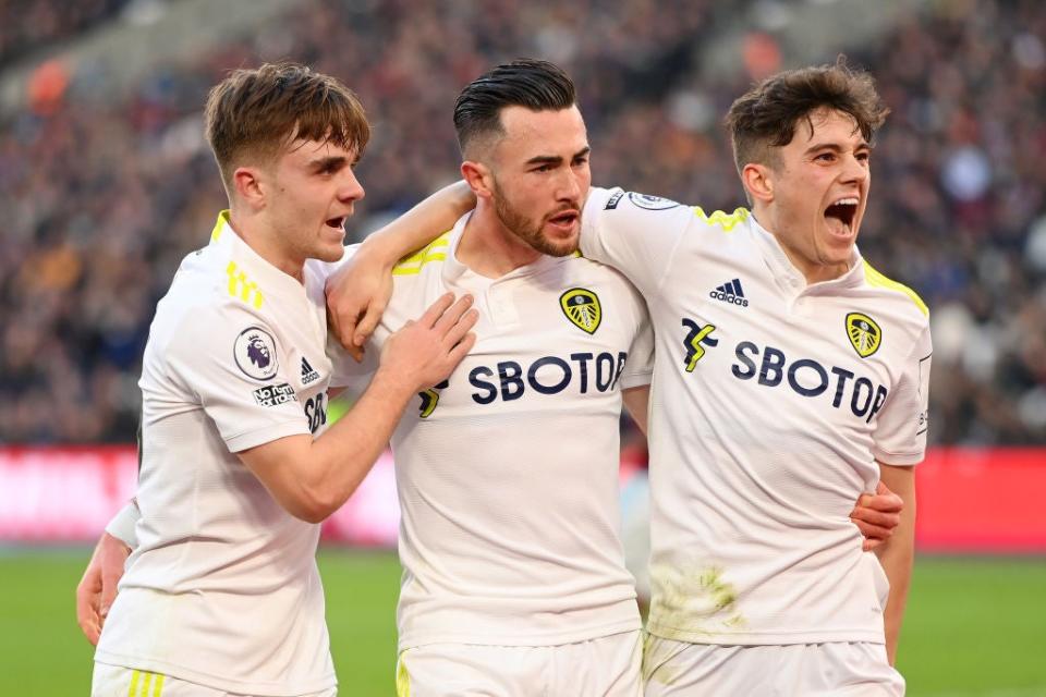 Harrison (centre) celebrates with teammates Lewis Bate and Daniel James after scoring his third goal (Getty)