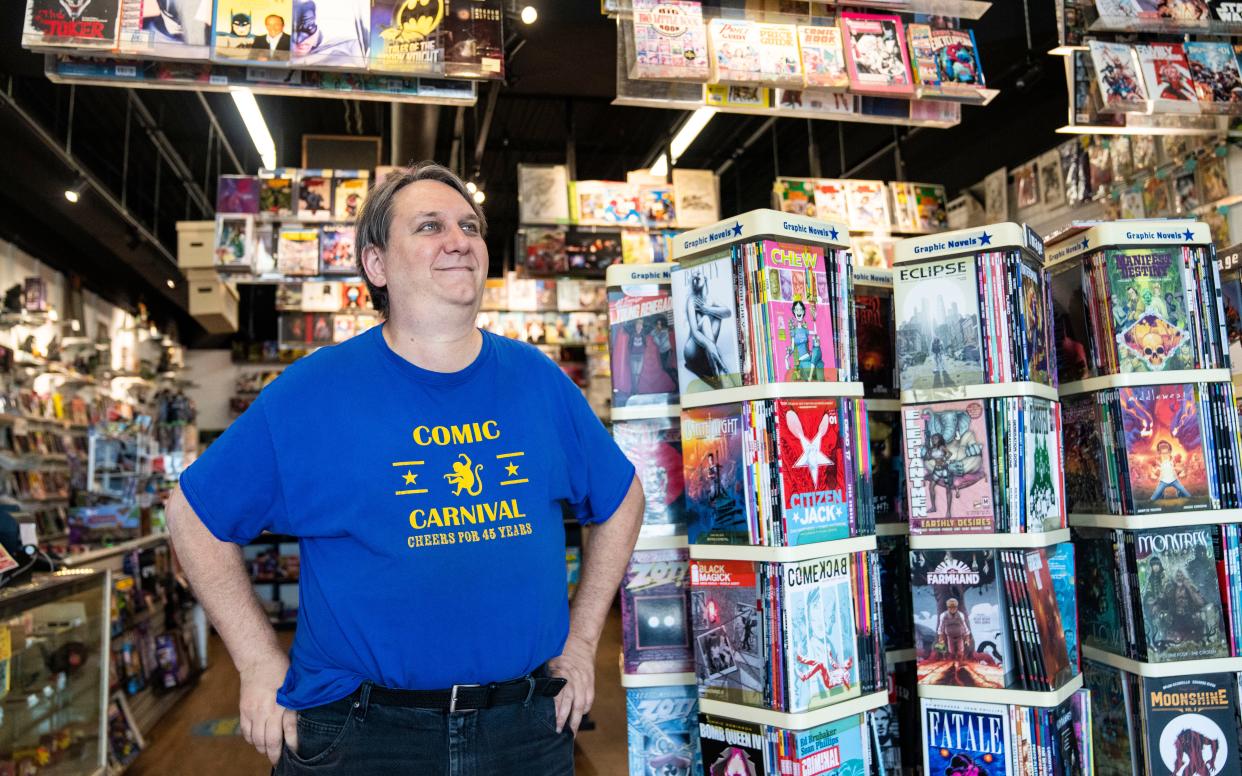 For 23 years, Tim Reynolds has enchanted the Midwest with comic books. Reynolds started working at Comic Carnival in 2000 alongside friend Dan Gaines. The pair went on to co-own the shop in 2015, and Comic Carnival has become one of the oldest comic book stores in the Midwest. Photographed on Friday, Aug. 4, 2023, at Comic Carnival on North Keystone in Indianapolis.
(Credit: Grace Hollars/IndyStar)