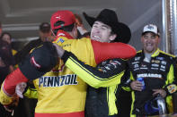 Ryan Blaney, right, gets a hug from Joey Logano in Victory Lane after Blaney won the NASCAR All-Star auto race at Texas Motor Speedway in Fort Worth, Texas, Sunday, May 22, 2022. (AP Photo/Larry Papke)