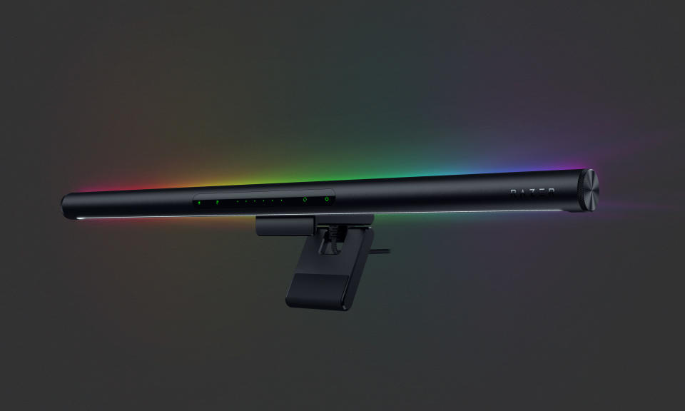 Product marketing image of Razer's Aether Monitor Light Bar. The elongated bar, viewed from an angle, emits RGB lighting above, behind and below.