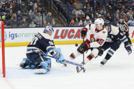 Columbus Blue Jackets' Elvis Merzlikins, left, makes a save against Ottawa Senators' Alex Formenton as Zach Werenski defends during the first period of an NHL hockey game, Sunday, Jan. 23, 2022, in Columbus, Ohio. (AP Photo/Jay LaPrete)